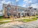 Inviting townhome featuring a combination of brick and siding, with professionally maintained landscaping at 6830 Colonial Garden Dr, Huntersville, NC 28078