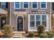 Detailed front entrance view with trimmed bushes, a tidy entrance, and well-defined architectural details at 6830 Colonial Garden Dr, Huntersville, NC 28078