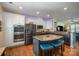 Modern kitchen with stainless steel appliances, granite countertops, and a large island with seating at 6830 Colonial Garden Dr, Huntersville, NC 28078