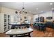 This kitchen features modern stainless appliances, a large granite island, and a casual dining area at 6830 Colonial Garden Dr, Huntersville, NC 28078