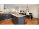 Open-concept kitchen with granite countertops, island seating, and wood flooring perfect for entertaining at 6830 Colonial Garden Dr, Huntersville, NC 28078