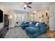 Relaxing living room featuring a comfortable sofa, neutral walls, and a window with natural light at 6830 Colonial Garden Dr, Huntersville, NC 28078