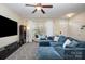 Bright living room featuring a large couch, large windows, and an inviting space at 6830 Colonial Garden Dr, Huntersville, NC 28078