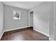 A bedroom with dark wood laminate flooring and a bright window at 77 Timothy Dan Ln, Taylorsville, NC 28681