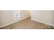 This bedroom features wood grain floors, neutral walls, and a window at 8137 Sheringham Way, Charlotte, NC 28227