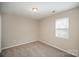 Cozy bedroom with neutral carpeting and a window providing natural light at 8137 Sheringham Way, Charlotte, NC 28227