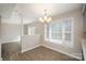 This light and airy dining room features wood grain floors, a chandelier, and large window at 8137 Sheringham Way, Charlotte, NC 28227