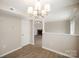 Open concept dining room features wood grain floors and view of the living room with fireplace at 8137 Sheringham Way, Charlotte, NC 28227