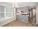 This bright kitchen features gray cabinets, stainless steel appliances, and wood grain flooring at 8137 Sheringham Way, Charlotte, NC 28227