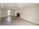 Living room featuring a brick fireplace, ceiling fan, and wood grain floors at 8137 Sheringham Way, Charlotte, NC 28227