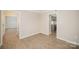 The living room features wood grain floors with stairway and kitchen views at 8137 Sheringham Way, Charlotte, NC 28227