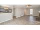 Open-concept living space connects to the kitchen, featuring wood grain floors and neutral walls at 8137 Sheringham Way, Charlotte, NC 28227