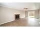 Spacious living room featuring a brick fireplace, ceiling fan, and sliding glass doors to a deck at 8137 Sheringham Way, Charlotte, NC 28227