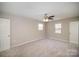 The main bedroom features neutral walls, carpet floors, and a ceiling fan at 8137 Sheringham Way, Charlotte, NC 28227