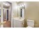 This bright, neutral bathroom has a white vanity and a hall view at 830 Wilcrest Ct, York, SC 29745