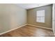 Neutral bedroom with a large window and wood-look flooring at 830 Wilcrest Ct, York, SC 29745