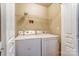Functional laundry area with washer, dryer and upper storage shelf at 830 Wilcrest Ct, York, SC 29745