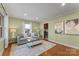 Inviting living room with hardwood floors, a gray sofa, and an open view into the adjacent kitchen at 831 Spruce St, Charlotte, NC 28203