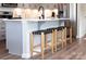 Kitchen island with barstool seating and stainless appliances, ideal for entertaining and casual dining at 9020 Northfield Crossing Dr, Charlotte, NC 28269
