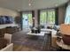 Bright living room features stylish decor, hardwood floors, and sliding glass doors to the patio at 9020 Northfield Crossing Dr, Charlotte, NC 28269