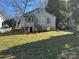 Backyard view showing the back of the house, with a covered porch and stairs at 909 Gibbons St, Gastonia, NC 28052