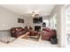 Open living room with tiled flooring, fireplace, ceiling fan, and door leading to backyard at 9232 Chislehurst Rd, Mint Hill, NC 28227