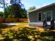 A well-maintained backyard featuring a tranquil area with a concrete pad and lush greenery at 101 Colony Acres Dr, Charlotte, NC 28217