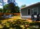 A landscaped backyard oasis with a cozy fire pit area and lush greenery for ultimate relaxation at 101 Colony Acres Dr, Charlotte, NC 28217