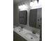 Bathroom featuring dual sinks with matching framed mirrors and modern fixtures at 101 Colony Acres Dr, Charlotte, NC 28217