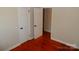 Bedroom with wood floors and two white panel doors at 101 Colony Acres Dr, Charlotte, NC 28217