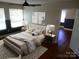 Staged bedroom with elegant furnishings, lamps, and dark hardwood floors at 101 Colony Acres Dr, Charlotte, NC 28217