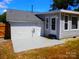 A charming home exterior showcasing a well-maintained patio with a serene backyard ambiance at 101 Colony Acres Dr, Charlotte, NC 28217