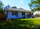 Charming single-story home with a well-maintained lawn and a welcoming yellow front door at 101 Colony Acres Dr, Charlotte, NC 28217