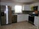 Bright kitchen with stainless steel appliances, white cabinets, and tiled backsplash at 101 Colony Acres Dr, Charlotte, NC 28217