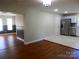Spacious living room with hardwood floors and views into the kitchen and front room at 101 Colony Acres Dr, Charlotte, NC 28217