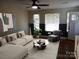 Staged living room with stylish decor, furniture, and dark hardwood floors at 101 Colony Acres Dr, Charlotte, NC 28217