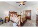 Inviting bedroom with a wooden bed frame, carpeted floors, and warm lighting at 101 Park View Dr, Belmont, NC 28012