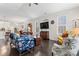 Spacious living room featuring hardwood floors, comfortable seating, a TV, and an open layout connecting to the kitchen at 101 Park View Dr, Belmont, NC 28012