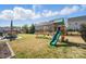 Private backyard featuring a play set, outdoor seating, well-maintained lawn, and secure fencing at 108 Hillston Ln, Mooresville, NC 28115