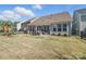 Wide backyard showcasing a patio with outdoor furniture, a swing set, and a well-maintained lawn at 108 Hillston Ln, Mooresville, NC 28115