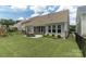 Backyard with a lush lawn, patio with dining area, framed by a fence and garden at 108 Hillston Ln, Mooresville, NC 28115
