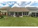 Backyard featuring a green lawn, patio dining set, and well maintained, landscaped garden beds at 108 Hillston Ln, Mooresville, NC 28115
