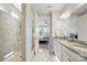 Bright bathroom featuring granite countertops, double sinks, and a walk-in shower with glass enclosure at 108 Hillston Ln, Mooresville, NC 28115