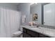 Well-lit bathroom features granite countertop, a white shower curtain, and gray walls at 108 Hillston Ln, Mooresville, NC 28115