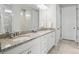 Bright bathroom featuring granite countertops, double sinks, and a spacious shower with glass enclosure at 108 Hillston Ln, Mooresville, NC 28115