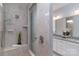 Tiled shower with glass door and built-in bench complements a bathroom with granite counters at 108 Hillston Ln, Mooresville, NC 28115
