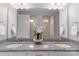 Modern bathroom with double vanity, granite countertop, decorative orchids, and large mirrors at 108 Hillston Ln, Mooresville, NC 28115