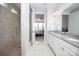 Bright bathroom featuring double sinks, granite counters and large walk-in tiled shower with glass door at 108 Hillston Ln, Mooresville, NC 28115