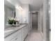 Bright bathroom boasts double sinks with granite counters, and a tiled shower and walk-in closet at 108 Hillston Ln, Mooresville, NC 28115