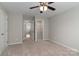 Neutral bedroom featuring carpet floors, ceiling fan, closet, and multiple entryways for convenience at 108 Hillston Ln, Mooresville, NC 28115
